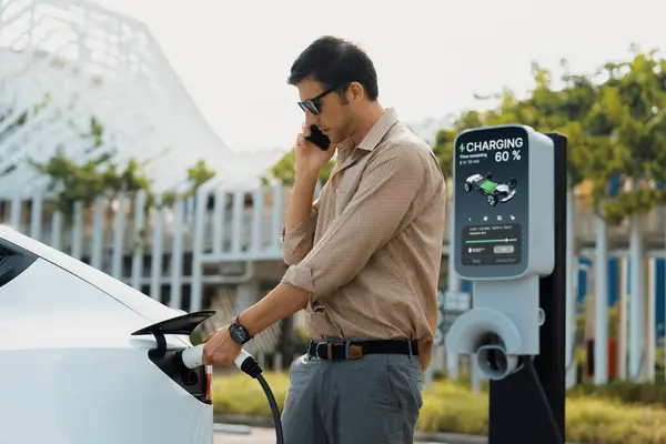 Driver charging electric vehicle